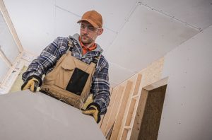 Resources 9 Man carrying sheet rock drywall